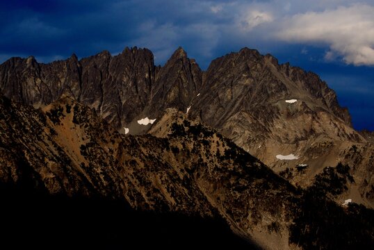Gorgeous rocky mountains at sunset with overcast sky