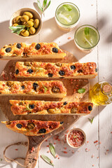 Fresh and traditional focaccia with olives and served with lemonade.