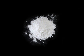 Pile of flour on black background