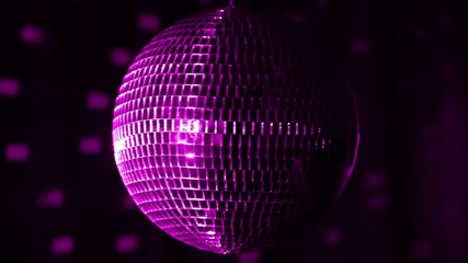 Sparkling disco ball illuminates vibrant atmosphere during late night dance party in intimate venue with energetic music