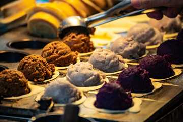 a vendor in the process of making hot and steaming wheel cakes