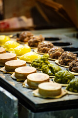 a vendor in the process of making hot and steaming wheel cakes