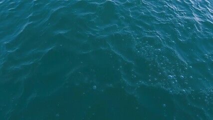Obraz premium Ocean surface with air bubbles creating a textured effect, ocean waves, wave patterns, ocean currents