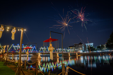  fireworks show at iron bridge across ping river where decorate with a lot of colorful light lanterns is highlight of yee peng loy krathong festival chiangmai thailand November 2024