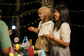 Group of Friends Preparing Gifts For Surprising on Birthday Celebration