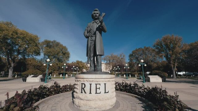 Historical monument shot at wide angle. The Louis Riel sculpture is a monument to Louis Riel located on the grounds of the Manitoba Legislative Building in Winnipeg. 