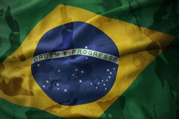 colourful waving flag of brazil on the old army khaki texture background. military concept.