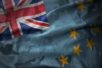 colourful waving flag of Tuvalu on the old army khaki texture background. military concept.