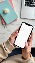 Obraz premium Hands holding smartphone with blank screen on marble desk