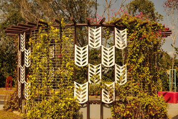 A park in a peaceful place featuring plants and leaf decorations that blend modern style with nature. The warm lighting and green surroundings make it a great spot to relax in Taman Tasik Puteri park.