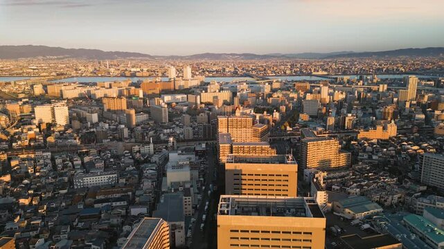 osaka city cityscape aerial view drone at sunrise flying to yodogawa district yodo river