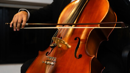 Close up A hand of Musician playing cello at orchestra classic concert 