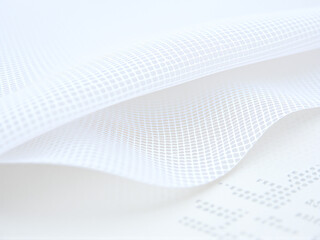 Fototapeta premium Soft white fabric with delicate texture highlighted in natural light
