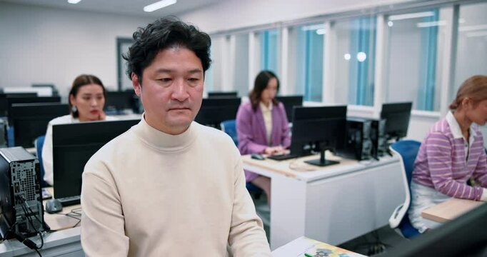 Japanese man, students and computer science in lab for lesson, education and learning for degree. Group, people and classroom in university or college for programming language, scholarship and school