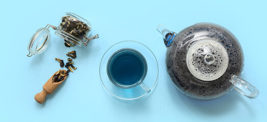 Composition with butterfly pea flower tea on light blue background, top view