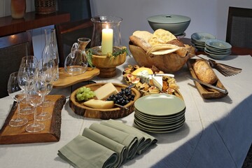 sophisticated table setting with breads, cheeses and assorted fruits