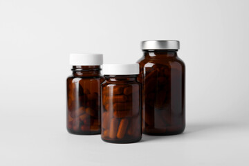 Medical bottles with pills on white background