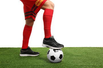 Football player with soccer ball on artificial grass against white background, closeup