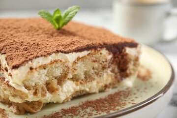 Piece of tasty tiramisu on table, closeup