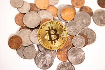 pile of coins with Bitcoin on top
