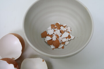 Eggshell ground on bowl. homemade calcium. whole and powdered eggshells, natural calcium, nutrient product. Can also be used as planting fertilizer after being crushed.