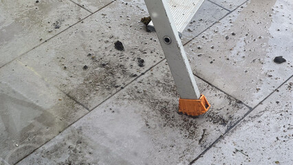 Wet tiled floor with debris and ladder © Florian Dussart