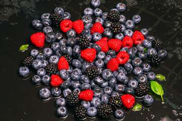 Wild berries background. Blueberry, raspberries, blackberry. Background of berries. Summer berries background. Mixed berries background.