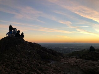 silhouette of a person on the top of mountain
