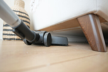 Utilizing a Vacuum Cleaner Under the Sofa for Highly Efficient and Thorough Cleaning