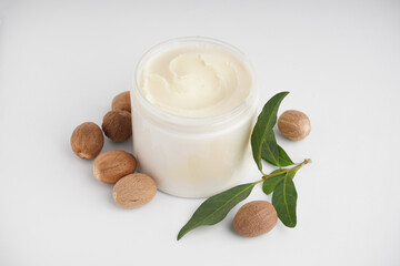 Jar with shea butter on white background
