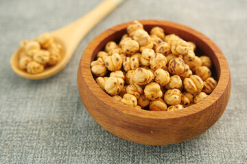 Wooden Bowl Filled with Roasted Chickpeas on a Rustic Table