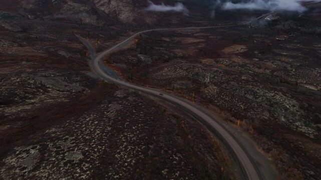 Scenic Drive On Dempster Highway Through Ogilvie Mountains In Yukon, Canada. aerial tilt-up shot
