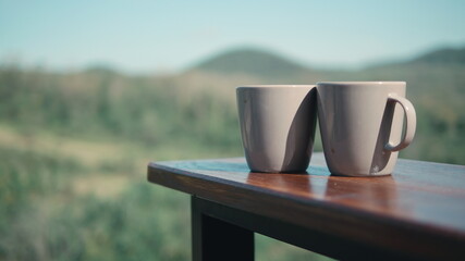 Pair of coffee cups and mountain view
