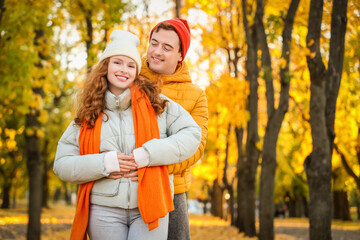 Fototapeta premium Beautiful loving young happy couple hugging in autumn park