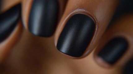 Close-up of manicured nails showcasing a matte black finish.