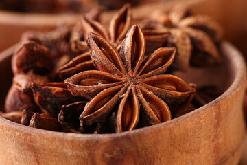 Wooden bowl with aromatic star anise, closeup