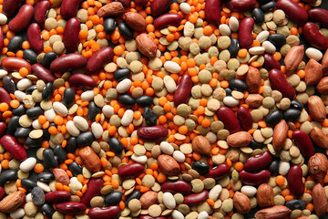 Heap of different raw legumes as background
