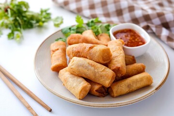 Deep fried vegetable spring rolls or egg rolls and sauce , Thai called popia on white background, vegetarian food