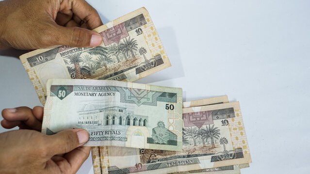 concept of counting Saudi riyal banknotes. Finnance, economic, income, tax concept.