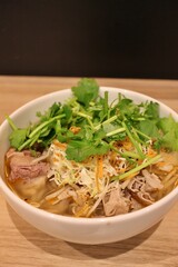 Vietnamese cuisine: bun bo hue (spicy rice noodles with beef tendon and coriander)