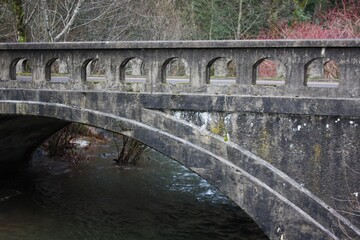 Fototapeta premium Historic Stone Arch Bridge over a Stream