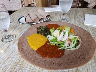Ethiopian Cuisine - Traditional Injera with Various Stews and Fresh Salad