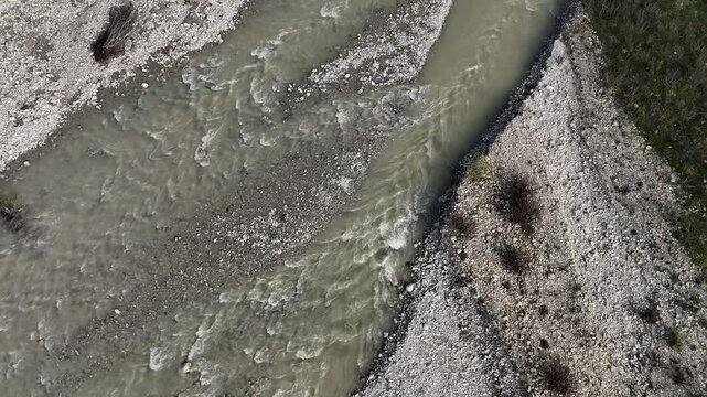 Arda River River lowing through a stony riverbed next to a road and some trees in Val Tolla, Lugagnano D'Arda, Piacenza, Italy, static shot