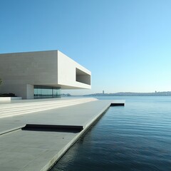 Obraz premium Modern architecture building by the water with a blue sky.