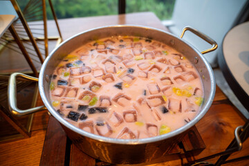 es campur or mixed ice is Indonesian fruit cocktail ice dessert mixed with shaved ice, condensed milk and syrup