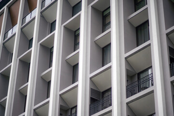 Perspective view of a facade of hotel building with classic style of windows, forming a pattern, as background