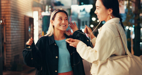 Earphones, music and smile with Japanese people in city for streaming, online playlist and radio. Happiness, bonding and podcast with asian friends listening to audio at night for album and support