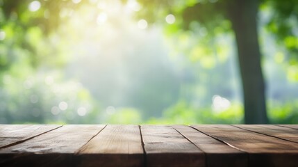 Wooden table on green summer park background and a blur effect in the background.