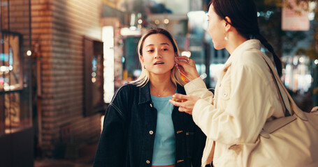 Earphones, music and share with Japanese friends in city for streaming, online playlist and radio. Technology, bonding and podcast with asian people listening to audio at night for album and support