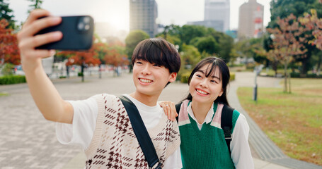Couple, selfie and smile in park for love, healthy relationship and memories for social media in Osaka. Japanese people, influencers and happy in city for photography, content creation or live stream